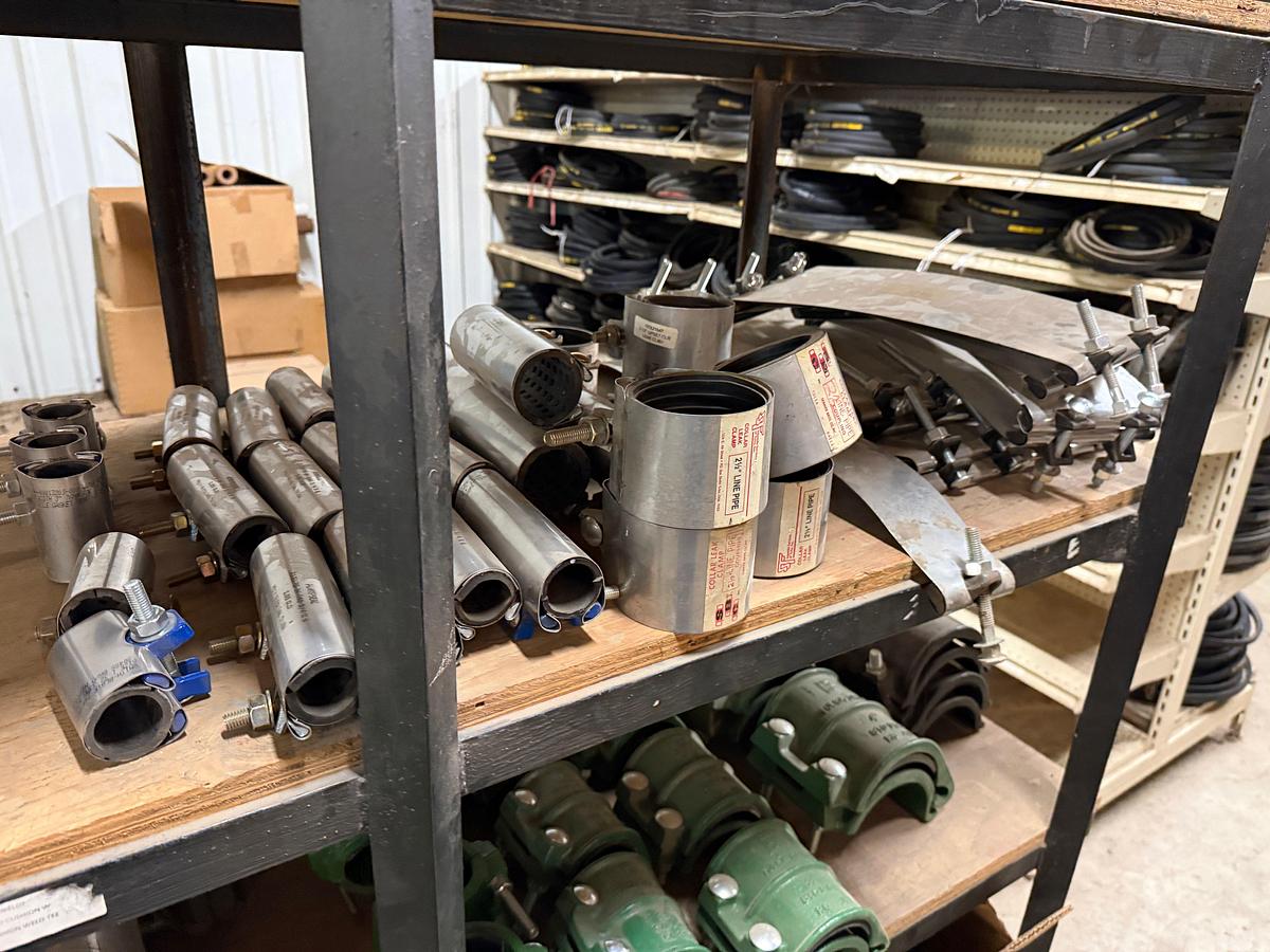 Used 5-SHELF RACK W/ CONTENTS OF PVC BALL VALVES & UNIONS, NETCO COLLAR LEAK REPAIR CLAMPS, (14+) BOXES 5/8” THRU 1” STUDS & NUTS