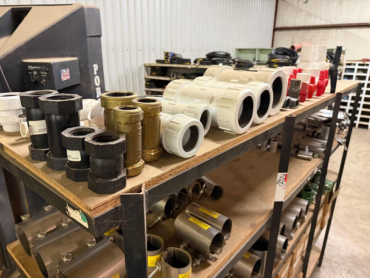Used 5-SHELF RACK W/ CONTENTS OF PVC BALL VALVES & UNIONS, NETCO COLLAR LEAK REPAIR CLAMPS, (14+) BOXES 5/8” THRU 1” STUDS & NUTS