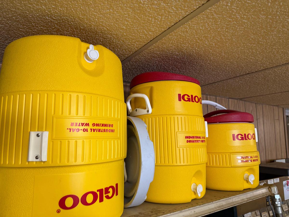 Used TOP SHELF W/ (3) 10-GAL IGLOO DRINKING COOLERS, (1) GPI ALUM HP-100 HAND PUMP, (2)EAGEL 5-GAL. SAFETY CANs