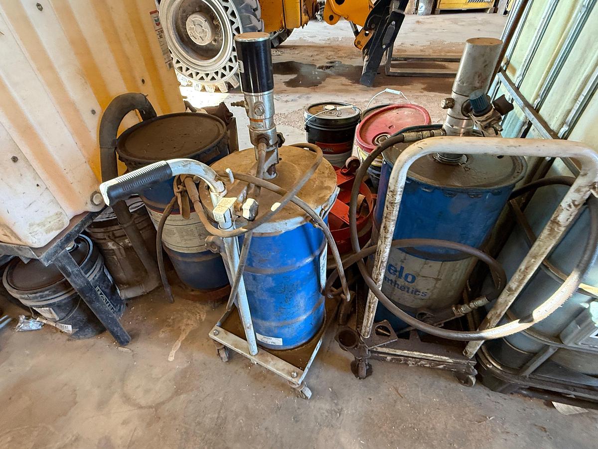 Used LOT W/ (2) 150-GALLON STEEL ROLLING OIL TANKS W/ AIR PUMPS, GUNS, & HOSES, (HAS SOME FLUID), (3) ROLLING LUBE BBLS, & RELATED