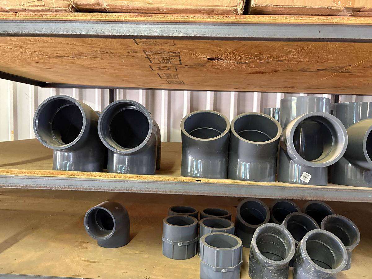 Used Contents of (5) shelves w/ U-line oil spill pads, various 2” to 4” PVC pipe fittings, etc.