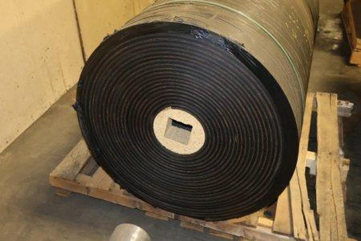 Used Price Rubber conveyor belt roll. Type: 2-P3-330. Features 1/4" x 1/16" covers. Label specifications: 48"W x 100'L. Net Weight: 1,287 lbs. Unused, mounted on pallet.