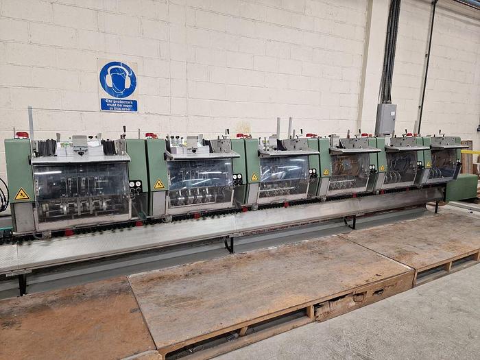 Used MULLER MARTINI BRAVO 6 Station Chain, 6 x 370 Feeders, 1 x Cover Feeder, Bravo Stitching Unit, Three Knife Trimmer, Pratico Stacker Delivery