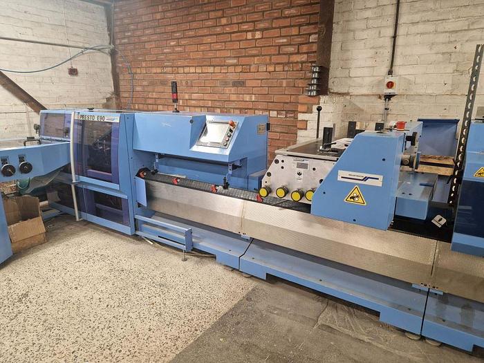 Used 2009 MULLER MARTINI E90 8 Station Chain, 8 x 1555 Feeders, 1528 Cover Feeder, E90 Stitching Unit, Three Knife Trimmer, Shingle Belt Delivery 