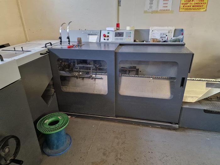 Used HEIDELBERG ST100 6 Station Chain, 6 x Auto Feeders, 1 x Cover Feeder, ST100 Stitching Unit, Three Knife Trimmer, Rima Stacker Delivery