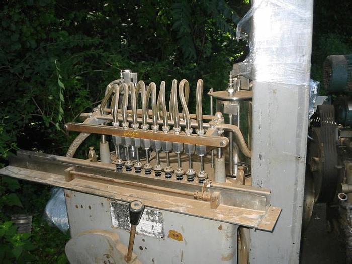 Used 9 HEAD U.S. BOTTLERS MACHINERY SEMI-AUTOMATIC LIQUID FILLER