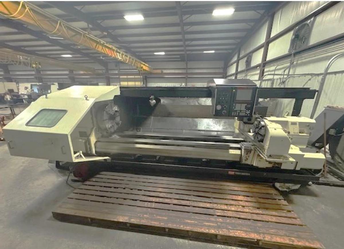 Used 2007 Mazak Powermaster 3000U w/ 10.2" Bore, (2) 18" 4 Jaw Manual Chucks, Chip Conveyor, Tailstock