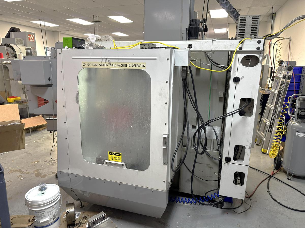Used 2002 Haas VF2D with Haas Rotary Table, 24 Station Side Mount ATC, Chip Auger, Programmable Coolant
