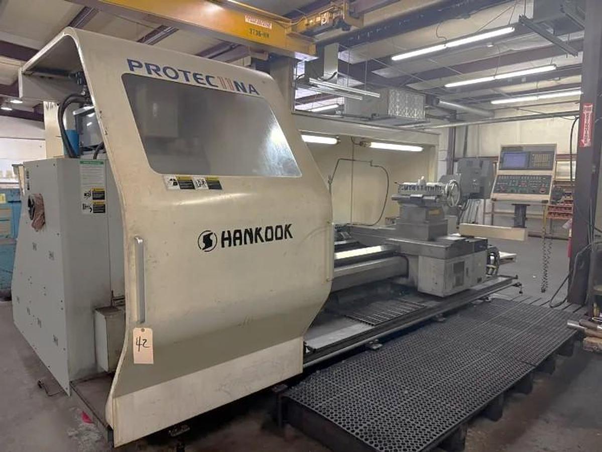 Used 2008 Hankook Protec 11NA with 43" sw, 29" Turn Diam, 78" cc, 4 Tool Manual Turret, Tailstock, Fanuc 21iTB Control, Conveyor