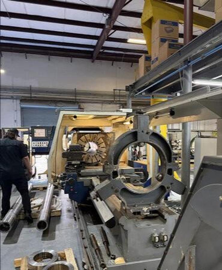 Used 2008 Weiler E90/2000 with 14" Bar Capacity, (2) 31" 4 Jaw Chucks, 80" cc, Chip Conveyor, Tailstock, Steady Rest, Weiler Control