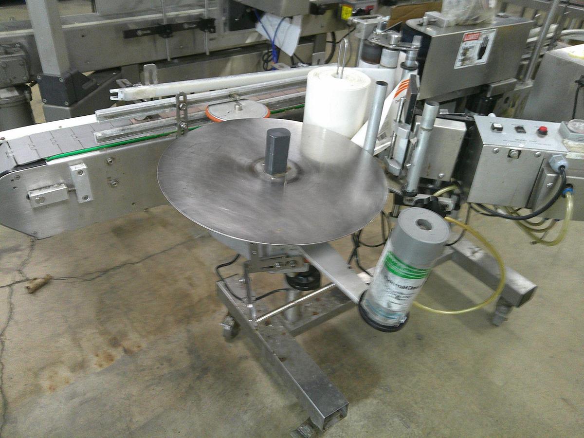 Used CVC 300 pressure sensitive wrap labeler