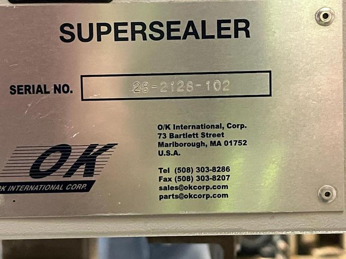Used OK band sealer with conveyor on stainless stand