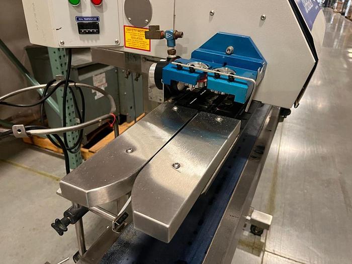 Used OK band sealer with conveyor on stainless stand