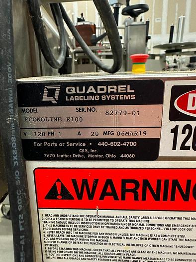 Used Quadrel E100 pressure sensitive wrap labeler for large bottles.