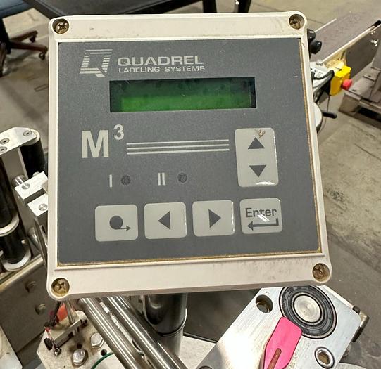 Used Quadrel E100 pressure sensitive wrap labeler for large bottles.