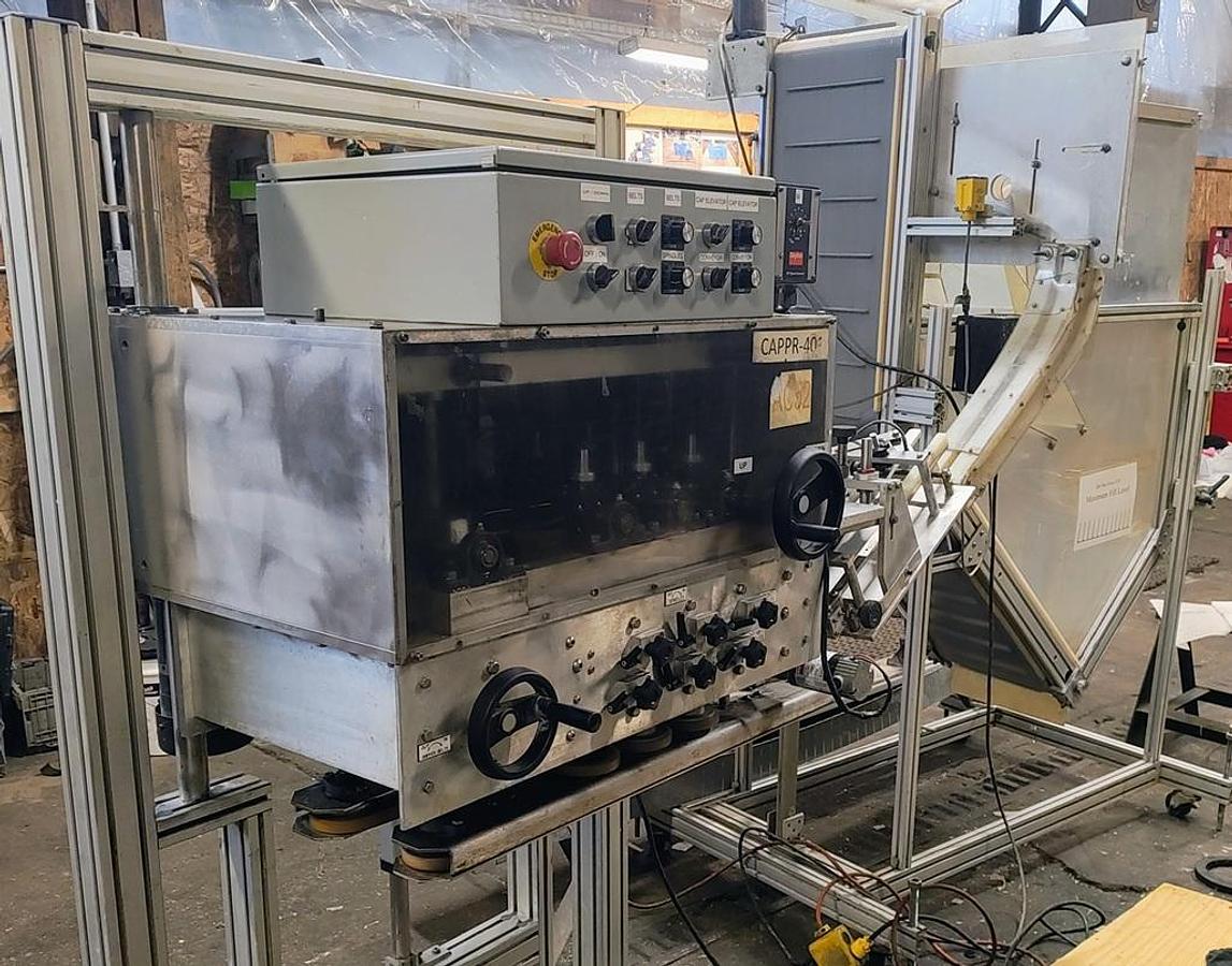 Used Equipment Express 6 quill capper with waterfall feeder