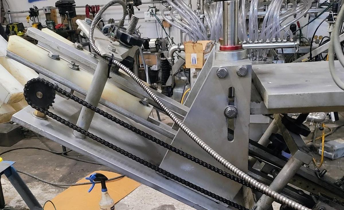 Used Equipment Express 6 quill capper with waterfall feeder