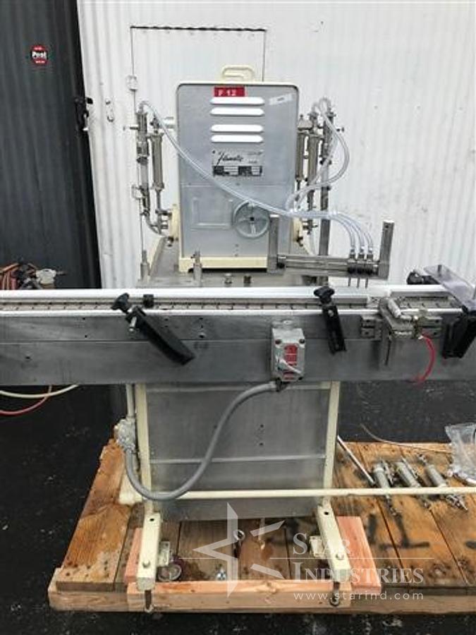 Used Filamatic Four Head Piston Filler With Conveyor