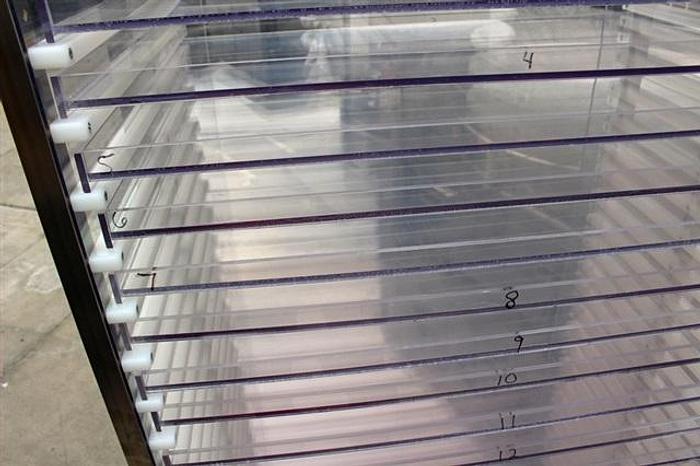 Used S.S. Rack w/ 24 30" x 20" Lexan-type Shelves, on wheels