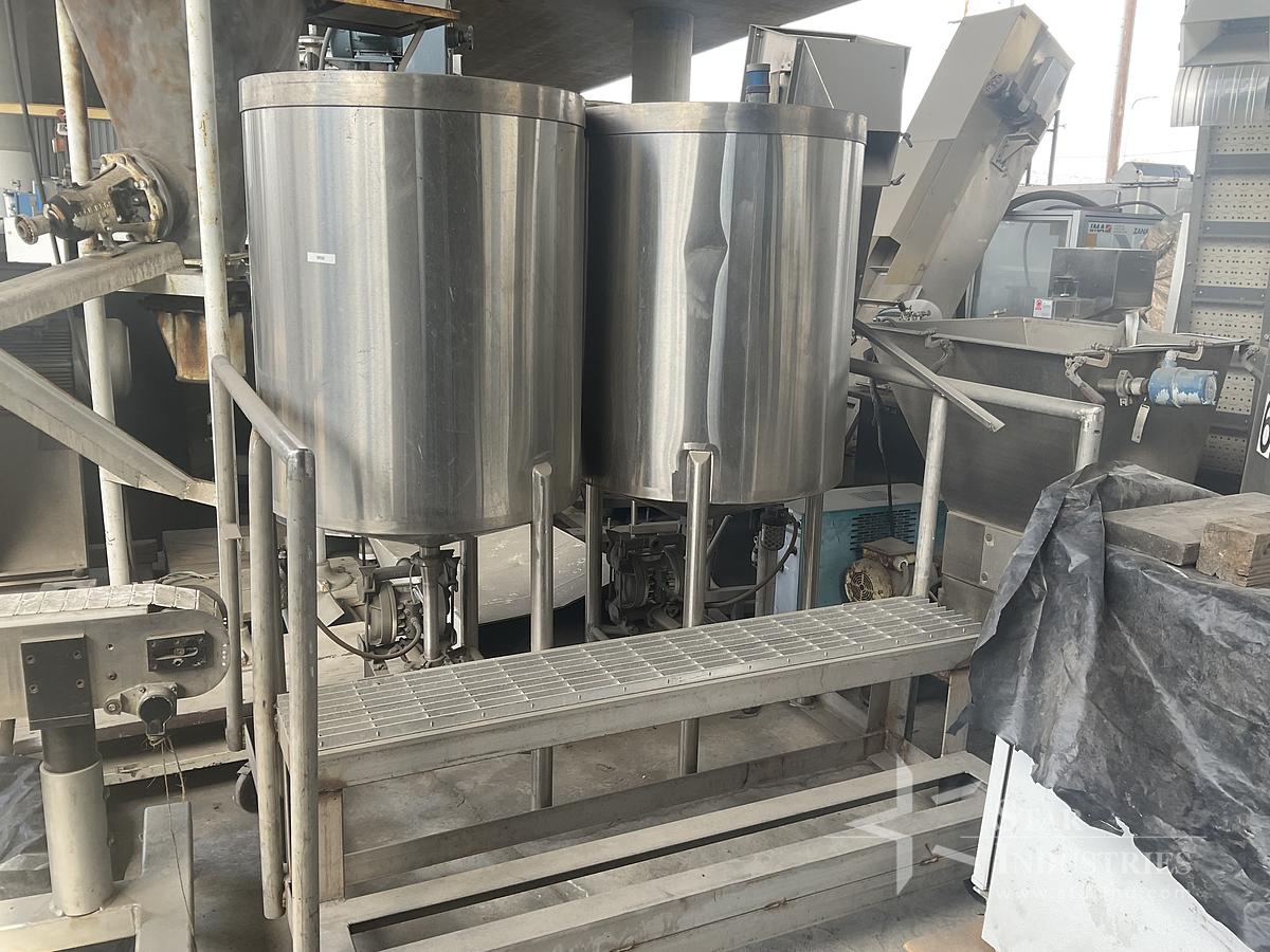 Used Twin 100 gallon S.S. Tanks w/ pumps on mezzanine