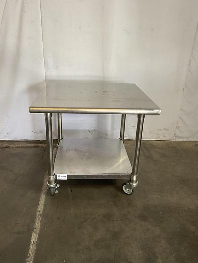Used STAINLESS STEEL ULINE ROLLING EQUIPMENT TABLE