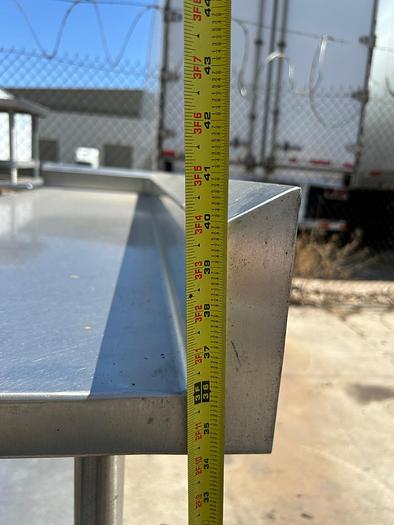 Used 7FT STAINLESS STEEL TABLE WITH BACK SPLASH AND CASTERS