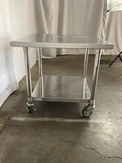 Used STAINLESS STEEL ULINE ROLLING EQUIPMENT TABLE