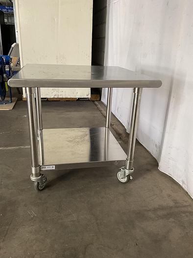 Used STAINLESS STEEL ULINE ROLLING EQUIPMENT TABLE