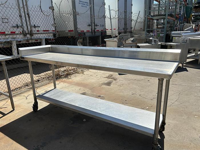 Used 7FT STAINLESS STEEL TABLE WITH BACK SPLASH AND CASTERS