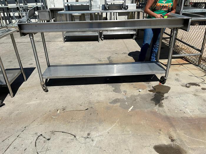 Used 7FT STAINLESS STEEL TABLE WITH BACK SPLASH AND CASTERS