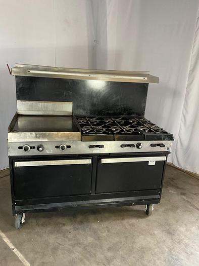 Used  6 BURNER RANGE WITH FLAT GRIDDLLE AND 2 STANDARD OVENS ./