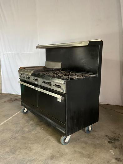 Used  6 BURNER RANGE WITH FLAT GRIDDLLE AND 2 STANDARD OVENS ./