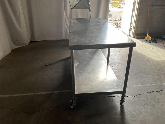 Used 72" COMMERCIAL TALBLE WITH CASTERS !