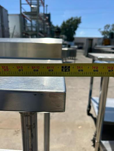 Used 7FT STAINLESS STEEL TABLE WITH BACK SPLASH AND CASTERS