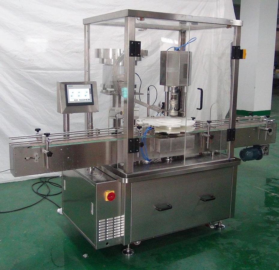 New Chuck Capper Model 100A with Conveyor.