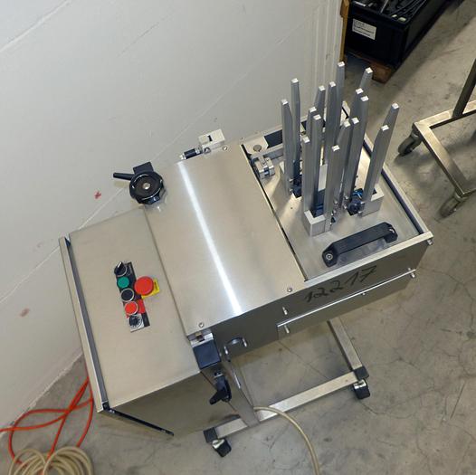 Used used Tray destacker in stainless steel for praline capsules made of paper.