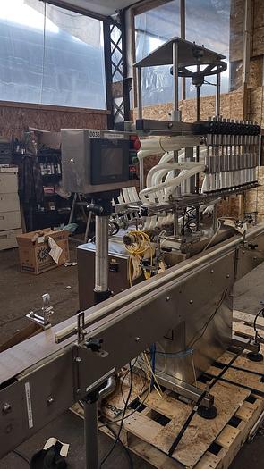 Used Inline Filling Systems - inline 12 spout pressure gravity filler with conveyor