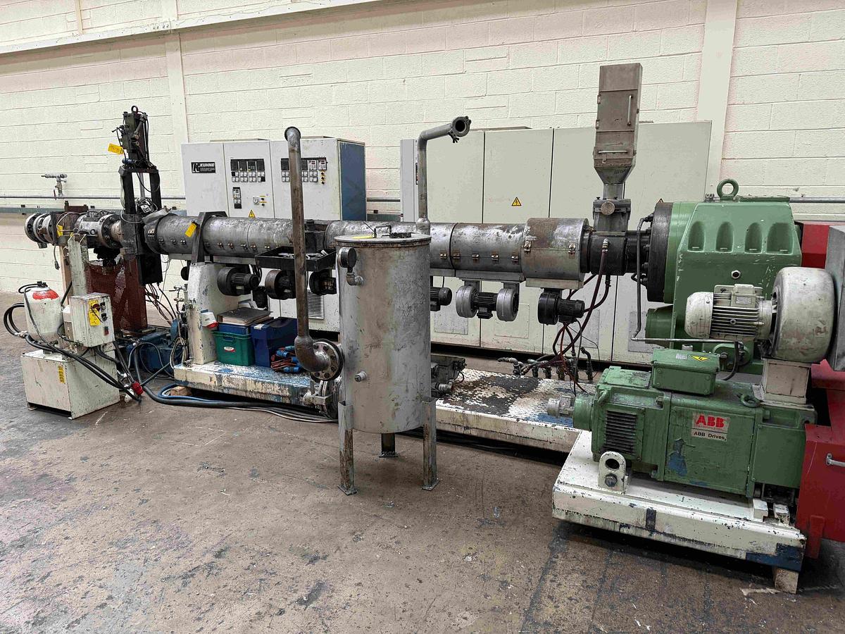 Used 105mm Kuhne single screw extruder model K105 - 33D. Fan cooled Vented with hydraulic screen changer,power pack, Maag 56/56 gear pump. 11kw motor.