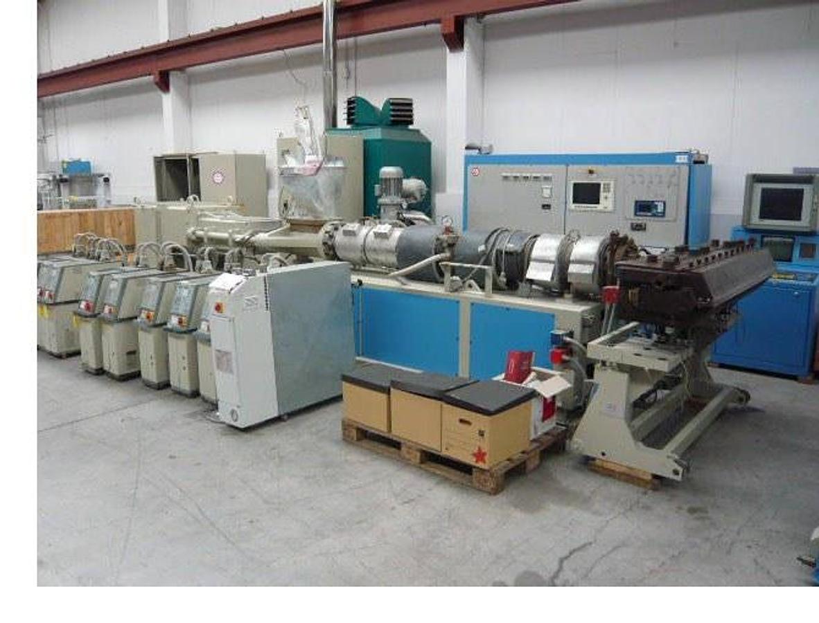 Used 1860mm wide Krauss Maffei Omipa sheet extrusion line. KMD130 Krauss Maffei extruder, 1800mm wide Omipa 3 roll stack, haul off, 2 station winder 1990