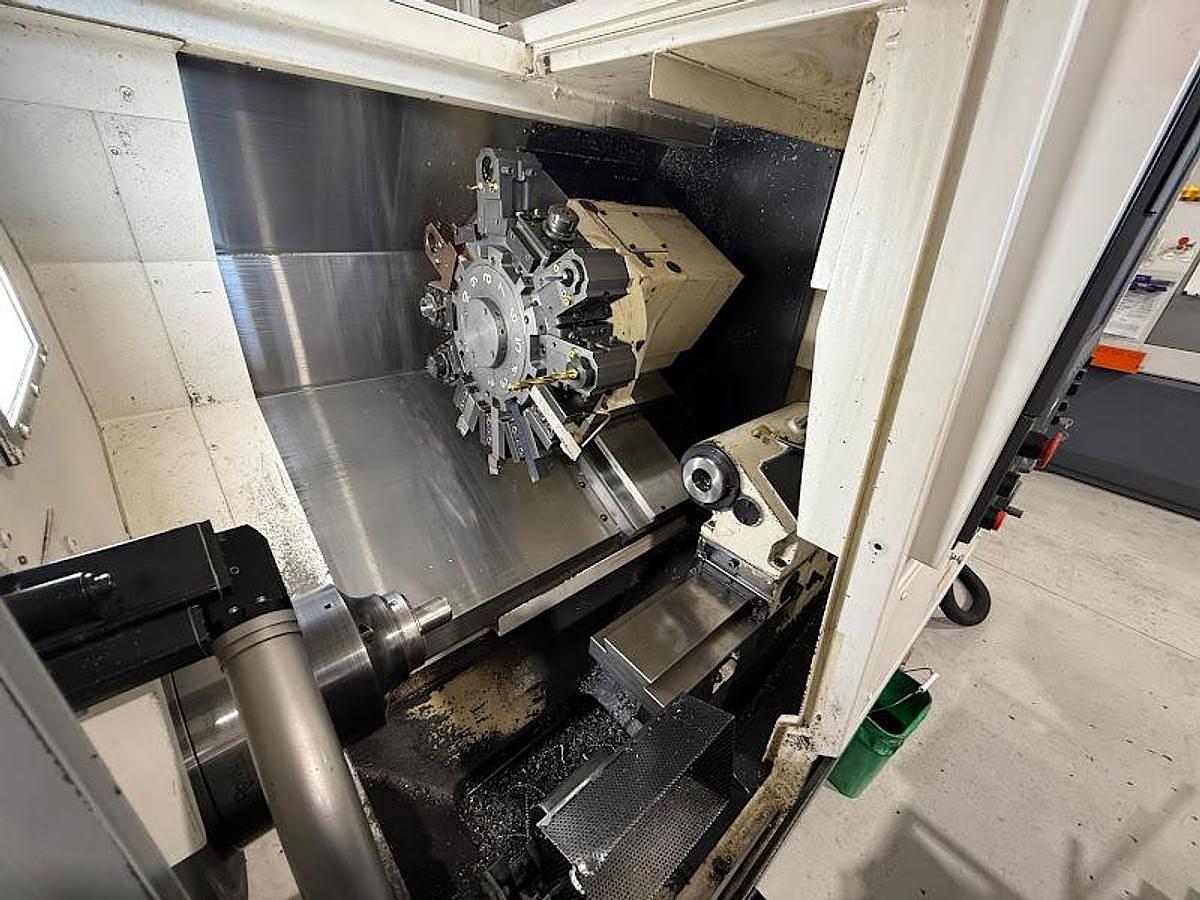 Used 2018 Okuma GENOS L300-M-e Lathe w/ Bar Feeder and Conveyor