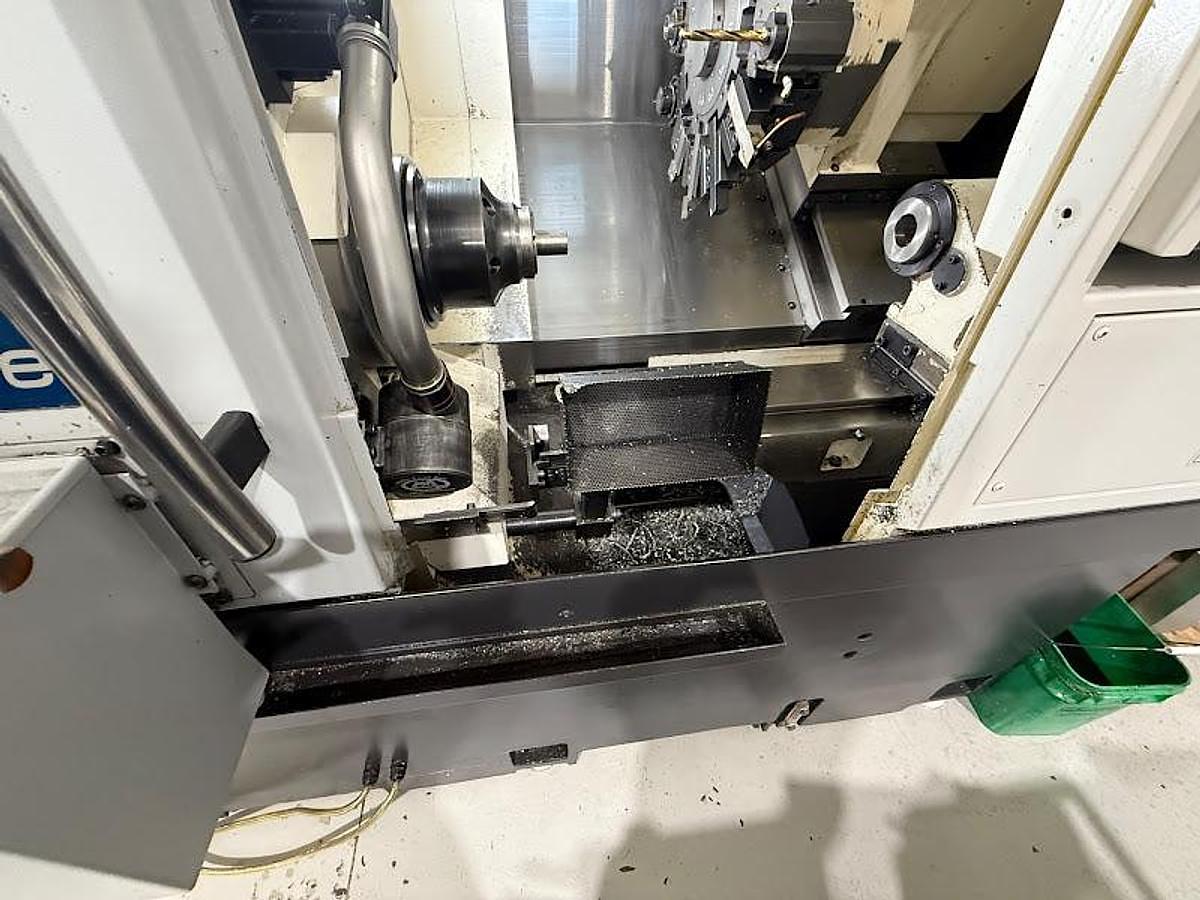 Used 2018 Okuma GENOS L300-M-e Lathe w/ Bar Feeder and Conveyor