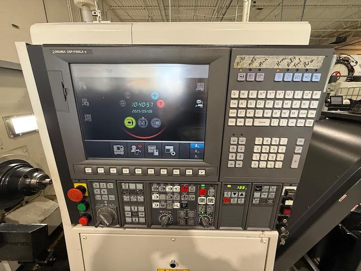 Used 2018 Okuma GENOS L300-M-e Lathe w/ Bar Feeder and Conveyor