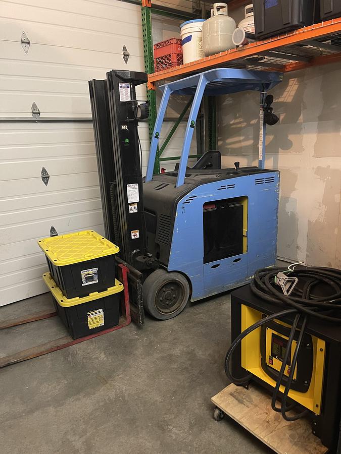 Used Forklift (model) with battery charger and 5 gallon mini pump
