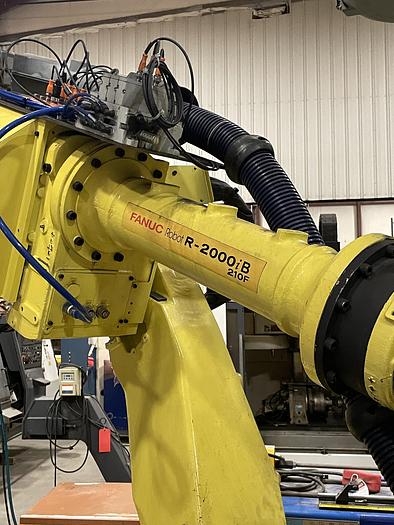 Used FANUC R-2000iB/210F ROBOT RTU CELL WITH 2 ROBOTS, R30IA CONTROLS AND 50' OF TRAVEL.