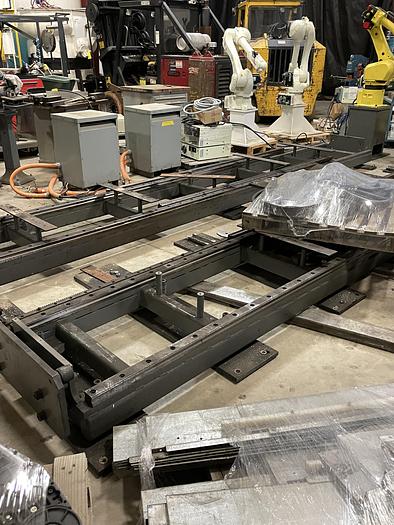 Used FANUC R-2000iB/210F ROBOT RTU CELL WITH 2 ROBOTS, R30IA CONTROLS AND 50' OF TRAVEL.