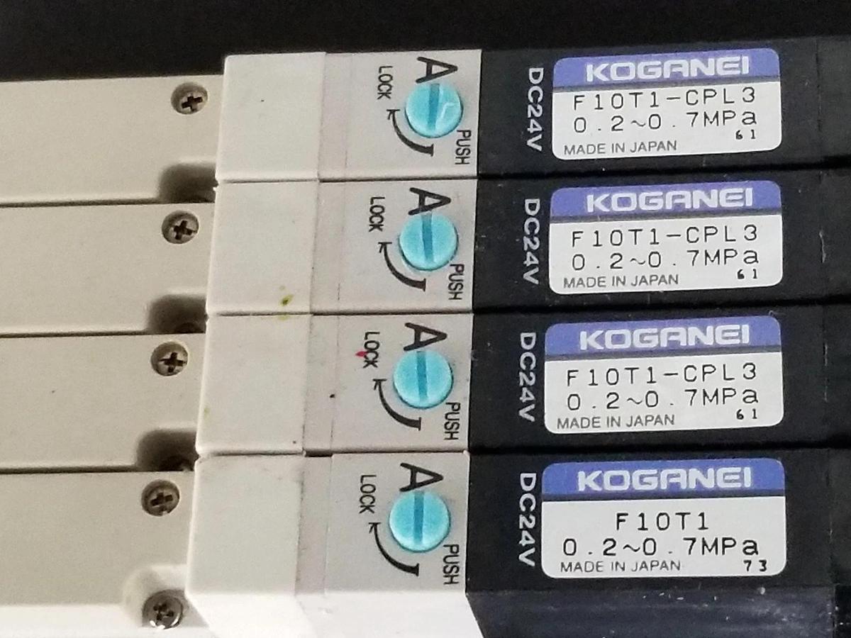 Used KOGANEI F10M6AJ MANIFOLD W/ FOUR F10T1-CPL3 SOLENOID VALVES, DC24V