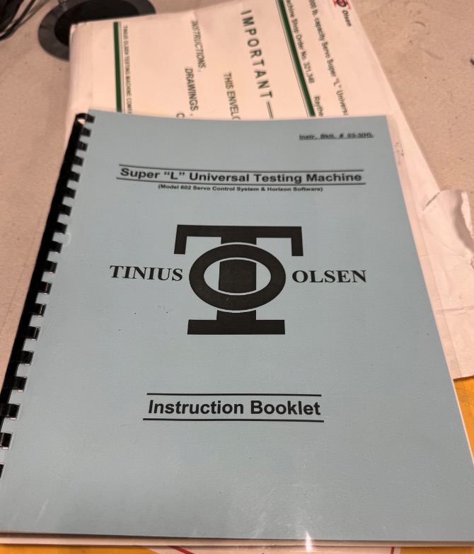 Used 2015 Tinius Olsen Super "L" Hydraulic Universal Testing Machine with Pressure Transducer Weighing, Servovalve Loading System, Model 602 Remote Display & Controller w/ Epsilon 3542 Extensometers