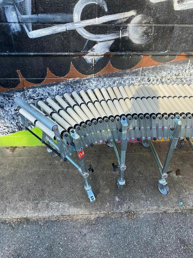 Used Matrex 89500 Portable Expandable Roller Conveyor, 6’ to 15’, On Casters