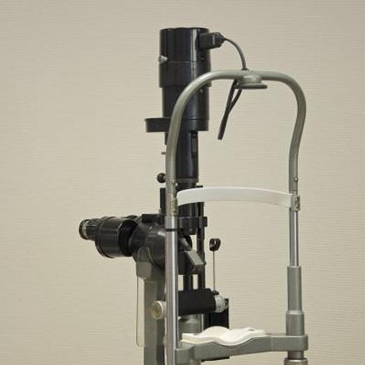Used MAGNON SLIT LAMP WITH THREE-DIMENSIONAL MOVEMENTS AND LEVELLING TONOMETER, ON HEIGHT-ADJUSTABLE TABLE WITH CASTORS