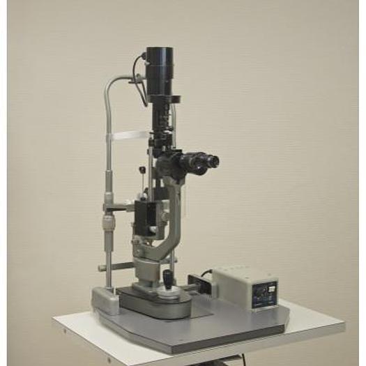 Used MAGNON SLIT LAMP WITH THREE-DIMENSIONAL MOVEMENTS AND LEVELLING TONOMETER, ON HEIGHT-ADJUSTABLE TABLE WITH CASTORS